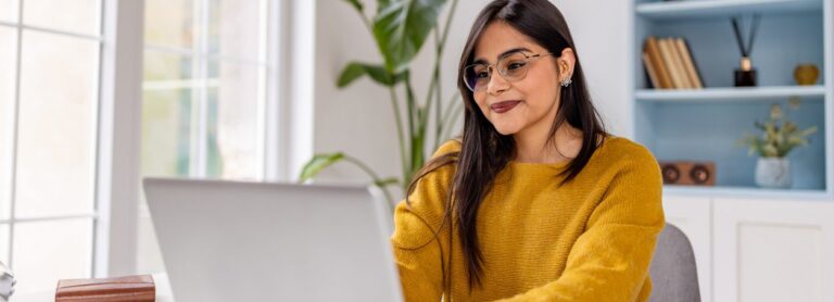 Content young woman sitting at her laptop typing