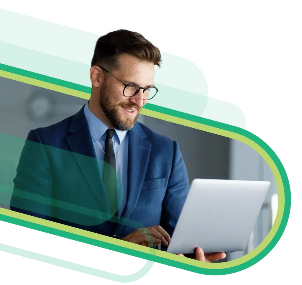 Man with glasses smiling while on laptop